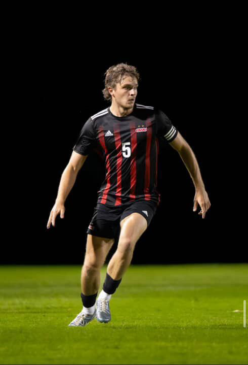 Soccer player competing under floodlights